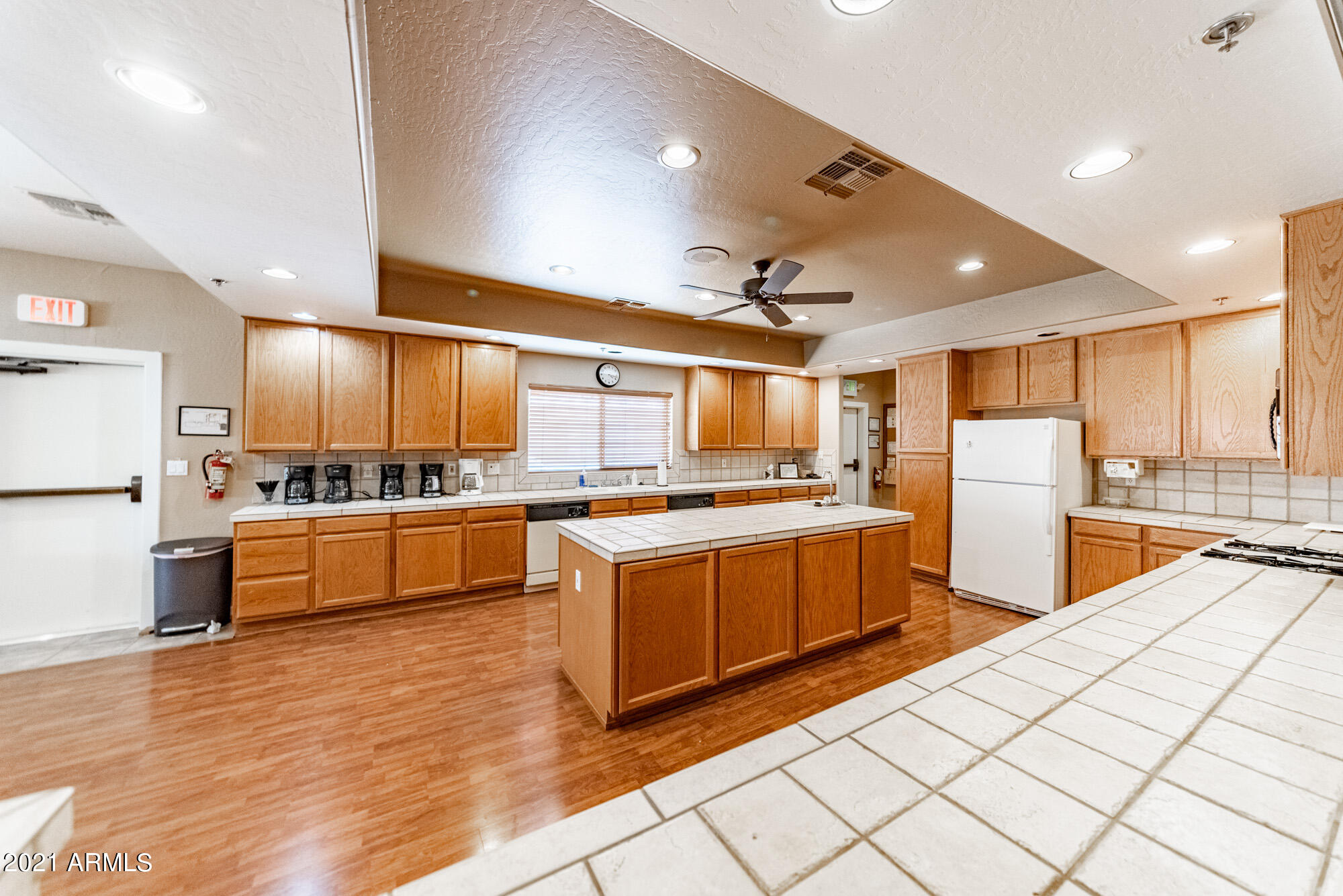 5830 East McKellips Road, Unit 56 Mesa, AZ 85215 - Photo 43 of 47 a kitchen with stainless steel appliances kitchen island granite countertop a stove and a refrigerator