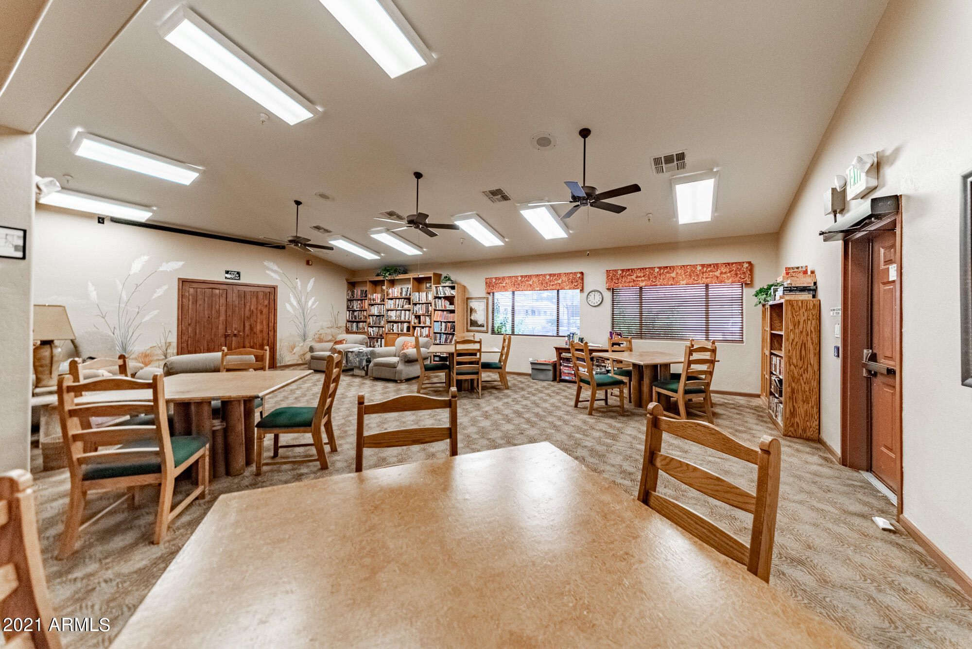 5830 East McKellips Road, Unit 56 Mesa, AZ 85215 - Photo 44 of 47 a view of a room with lots of wooden furniture and windows