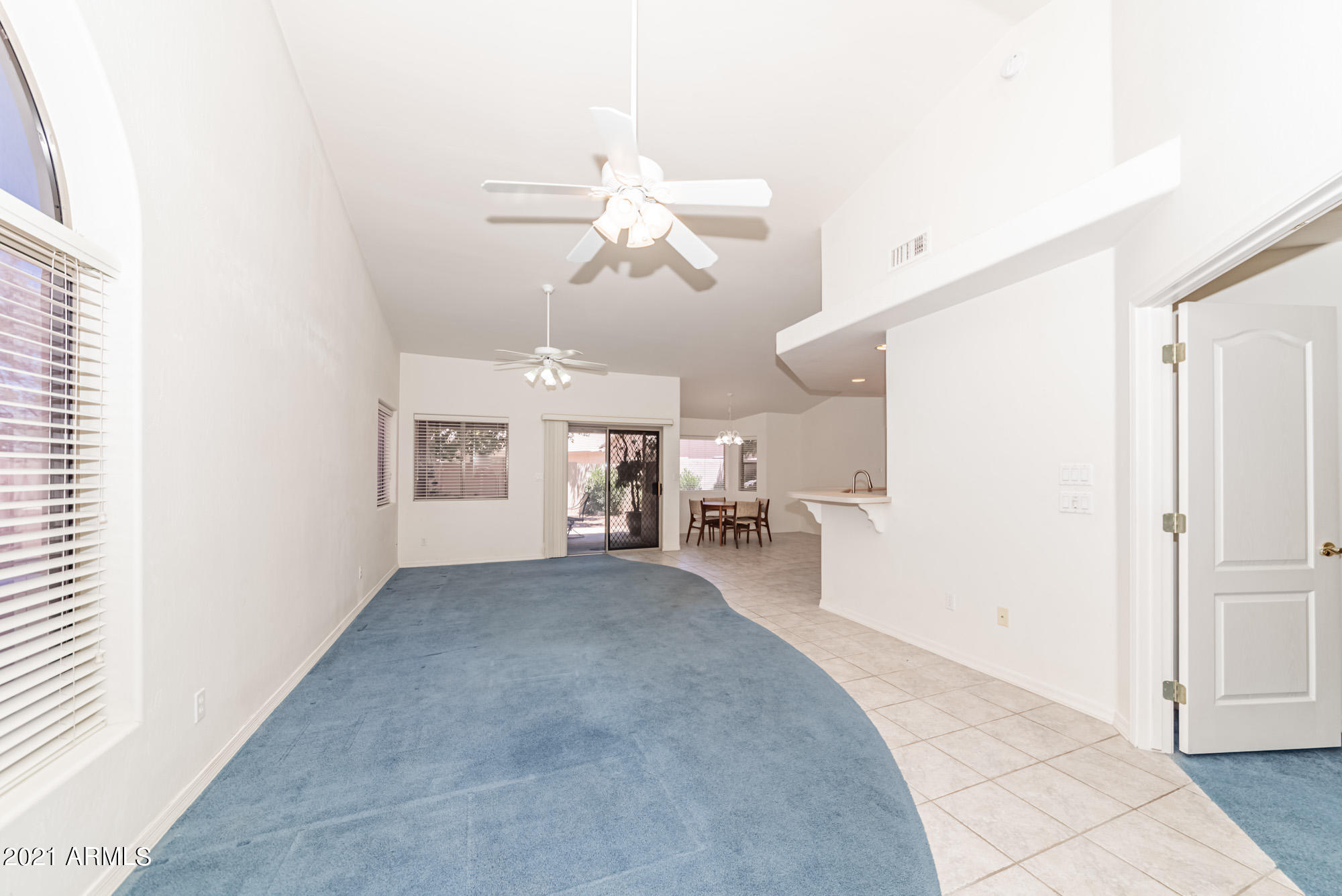 5830 East McKellips Road, Unit 56 Mesa, AZ 85215 - Photo 5 of 47 a view of a livingroom with a ceiling fan and window