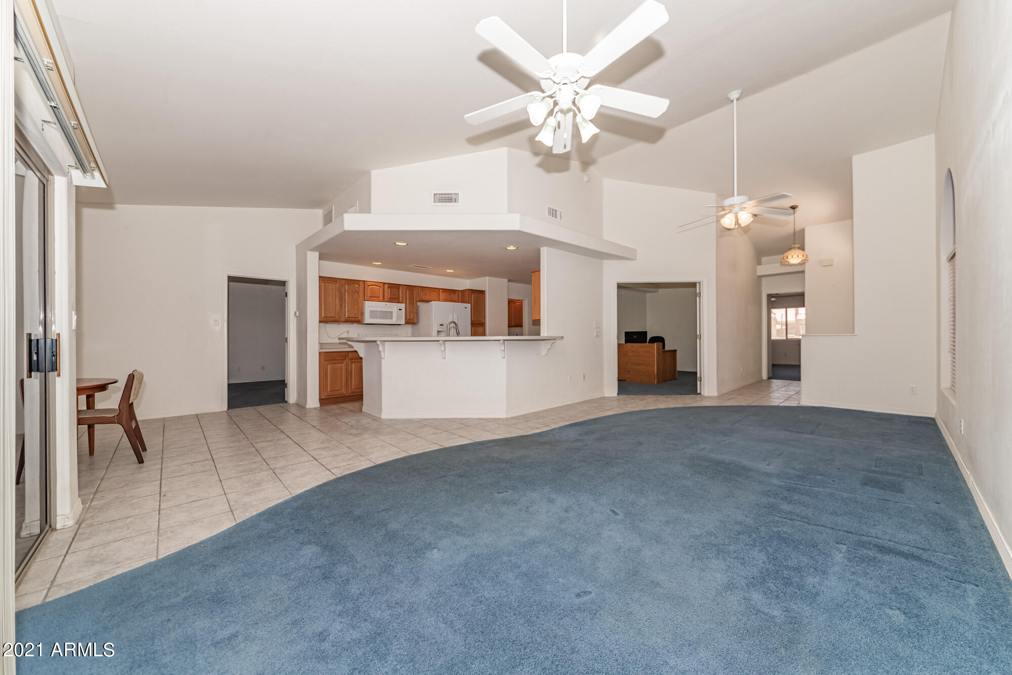 5830 East McKellips Road, Unit 56 Mesa, AZ 85215 - Photo 7 of 47 a view of a kitchen with a sink and a refrigerator