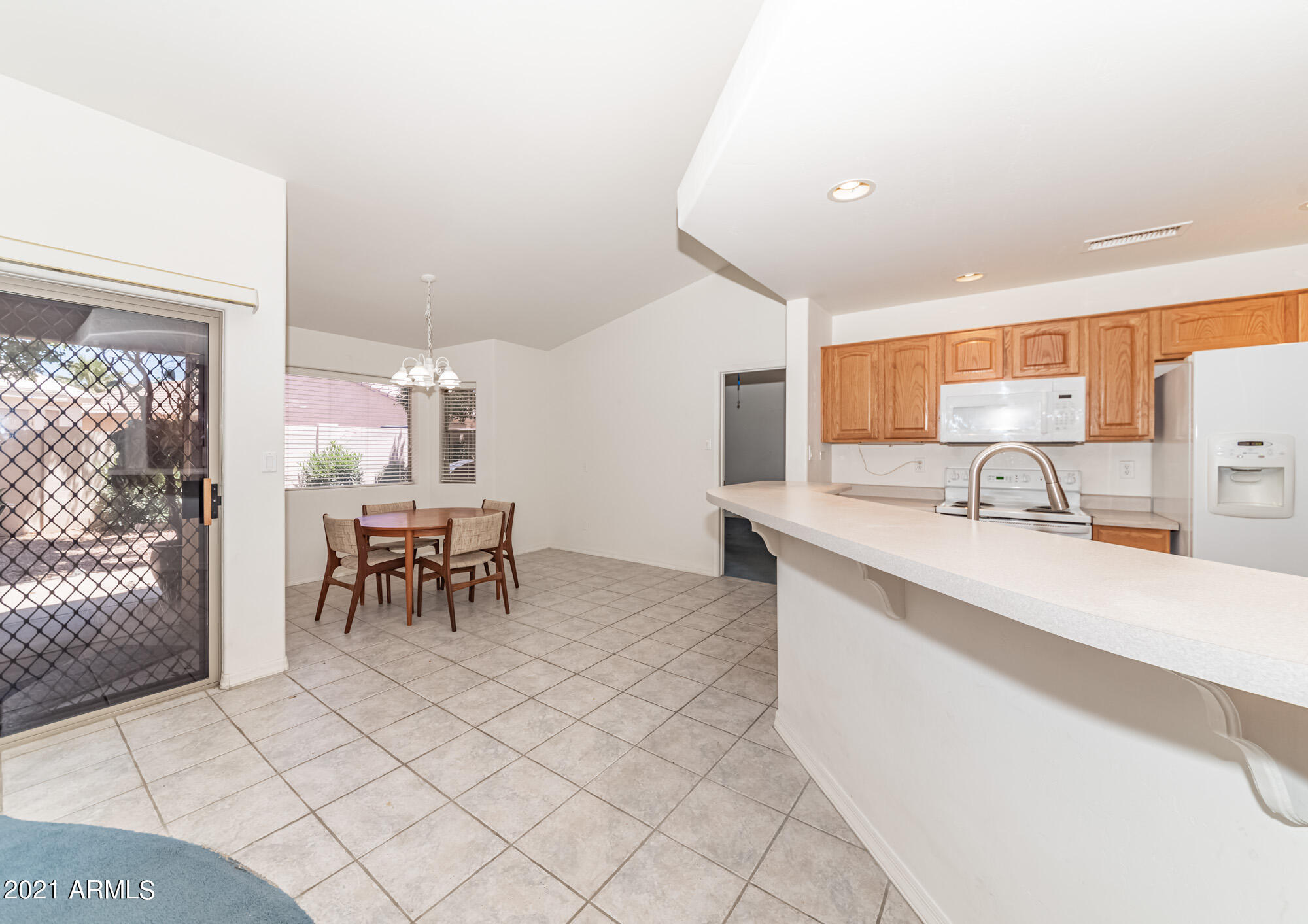 5830 East McKellips Road, Unit 56 Mesa, AZ 85215 - Photo 9 of 47 a kitchen with stainless steel appliances kitchen island granite countertop a sink and cabinets