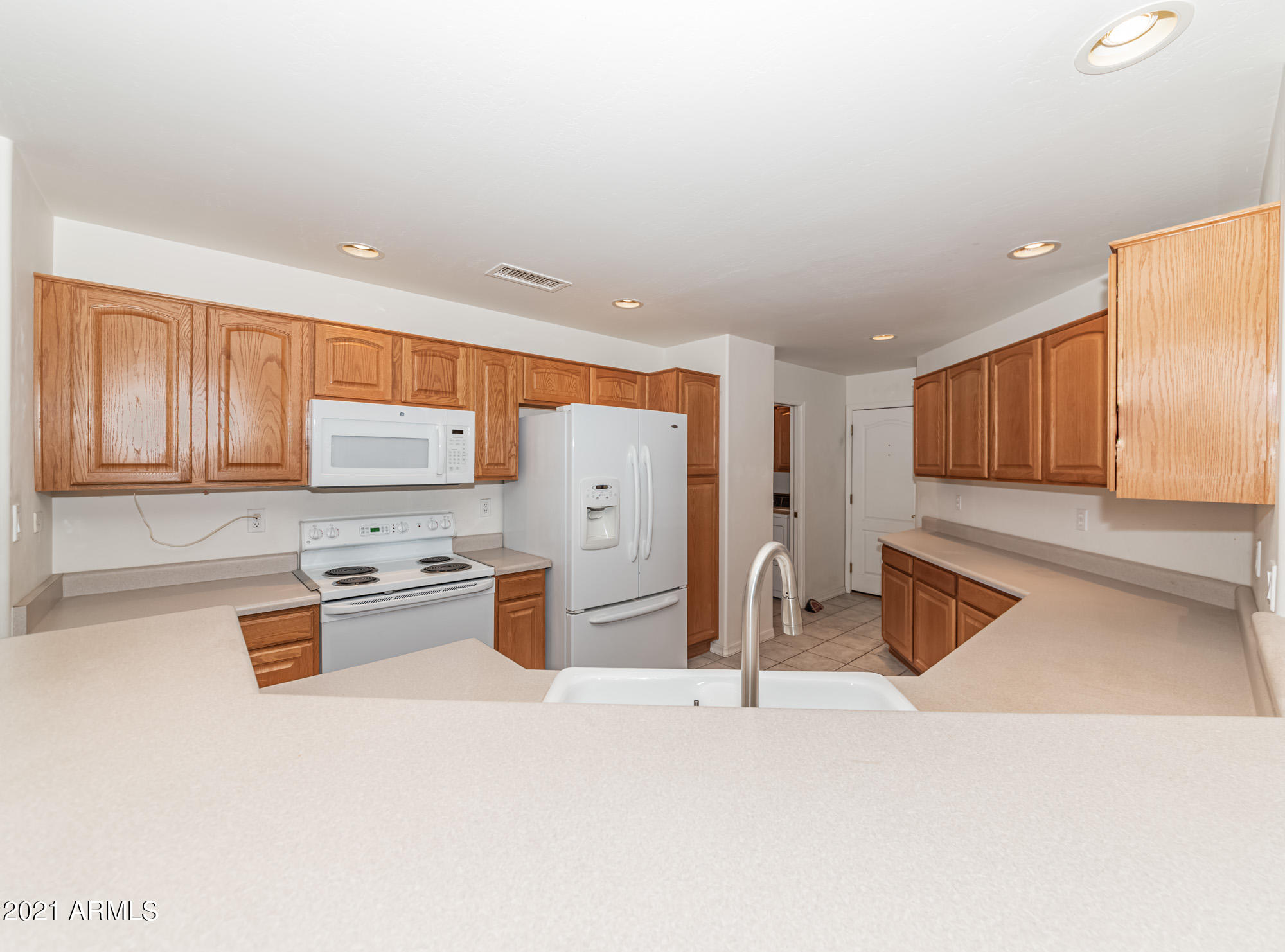 5830 East McKellips Road, Unit 56 Mesa, AZ 85215 - Photo 10 of 47 a kitchen with stainless steel appliances kitchen island granite countertop a refrigerator stove top oven and sink