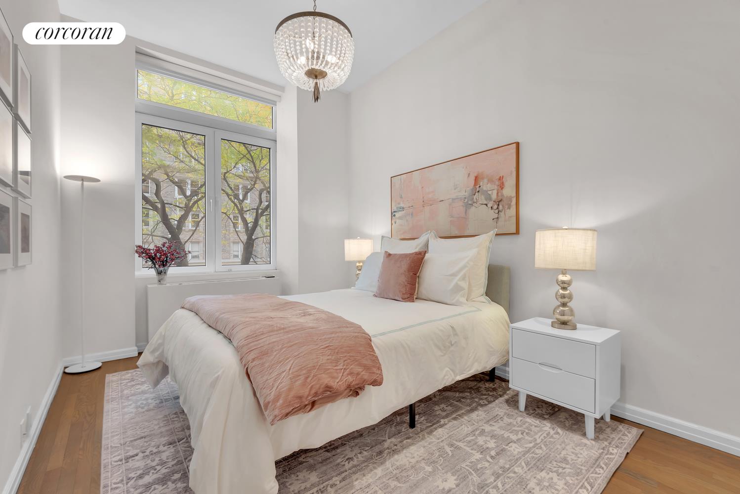 30 West 86th Street, Unit 2B Manhattan, NY 10024 - Photo 6 of 12 a bedroom with a large bed and a chandelier