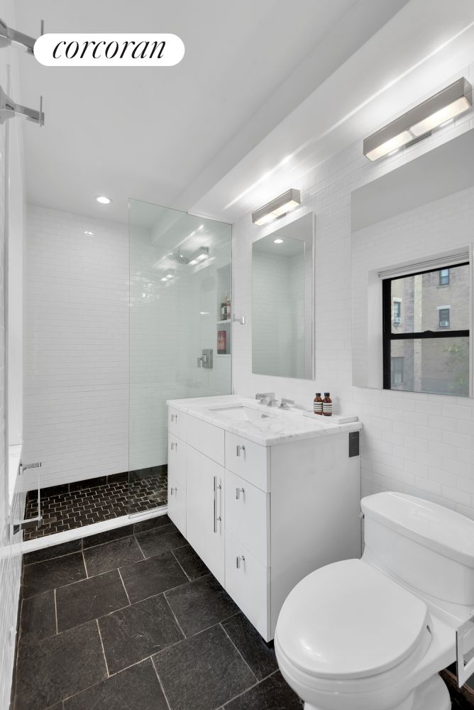 30 West 86th Street, Unit 2B Manhattan, NY 10024 - Photo 8 of 12 a bathroom with a sink a toilet and a mirror