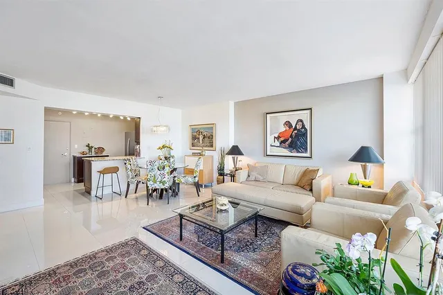 a living room with furniture potted plant and a table