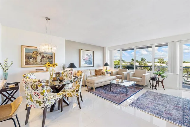 a living room with furniture dining table and a large window
