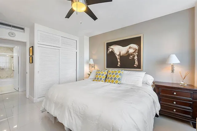 a bedroom with a bed and a painting on the wall