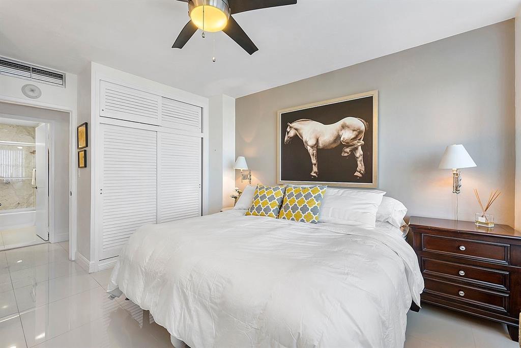 3300 Northeast 36th Street, Unit 303 Fort Lauderdale, FL 33308 - Photo 20 of 53 a bedroom with a bed and a painting on the wall