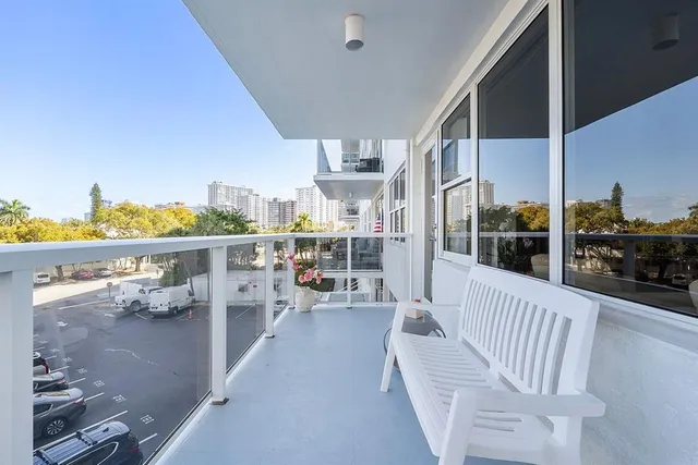 a balcony with furniture and view of city