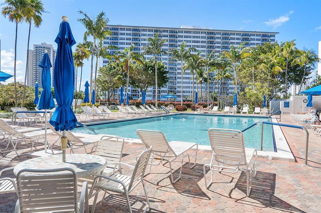 3300 Northeast 36th Street, Unit 303 Fort Lauderdale, FL 33308 - Photo 24 of 53 a view of swimming pool with outdoor seating and city view