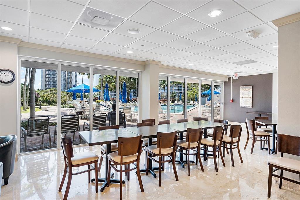 3300 Northeast 36th Street, Unit 303 Fort Lauderdale, FL 33308 - Photo 30 of 53 a view of a dining room with furniture window and outside view