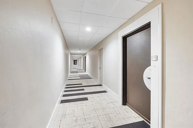 a view of a hallway with wooden floor and entryway