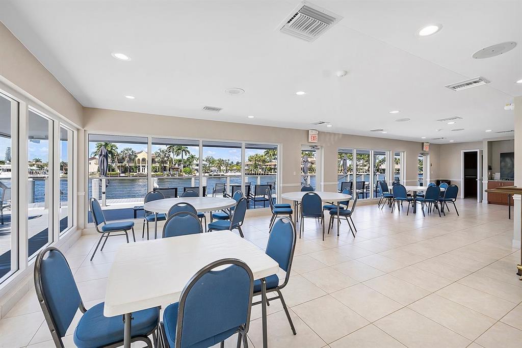 3300 Northeast 36th Street, Unit 303 Fort Lauderdale, FL 33308 - Photo 38 of 53 a dining room with furniture mountain view and a floor to ceiling window