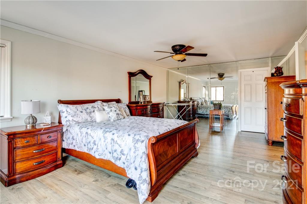 10043 Tepa Place Tega Cay, SC 29708 - Photo 12 of 32 a bed room with a bed and a chandelier