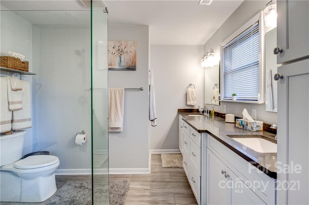 10043 Tepa Place Tega Cay, SC 29708 - Photo 13 of 32 a bathroom with a granite countertop sink toilet and shower