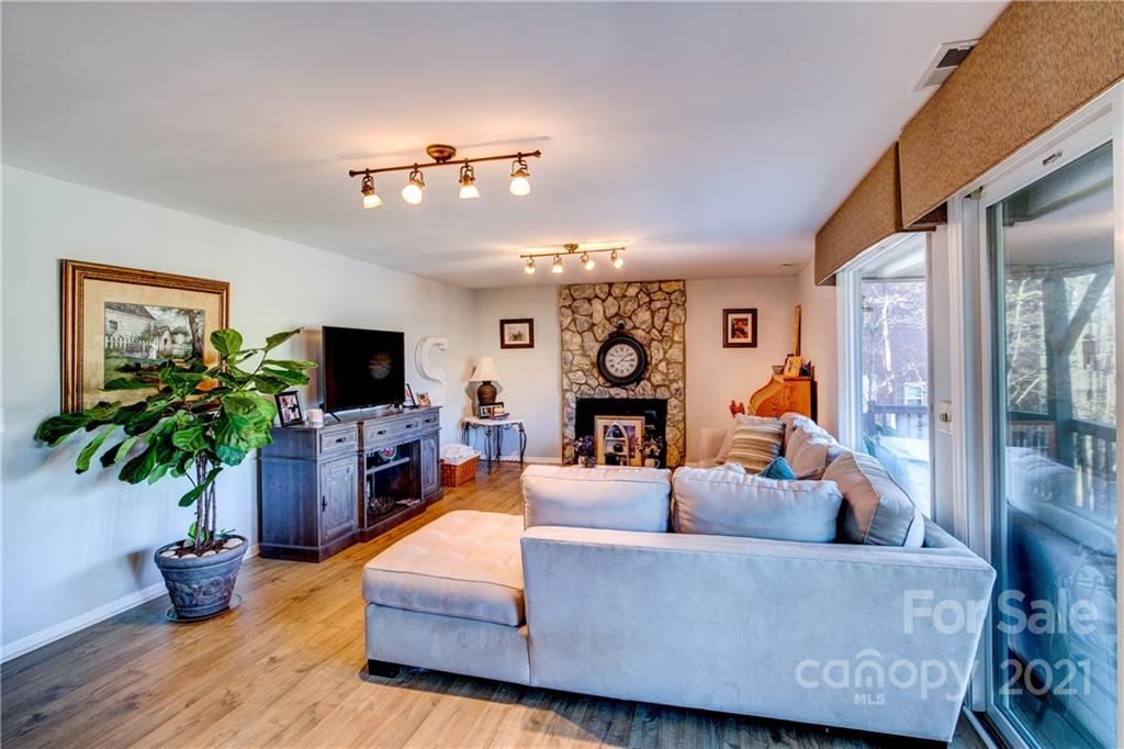 10043 Tepa Place Tega Cay, SC 29708 - Photo 15 of 32 a living room with furniture a flat screen tv and a potted plant