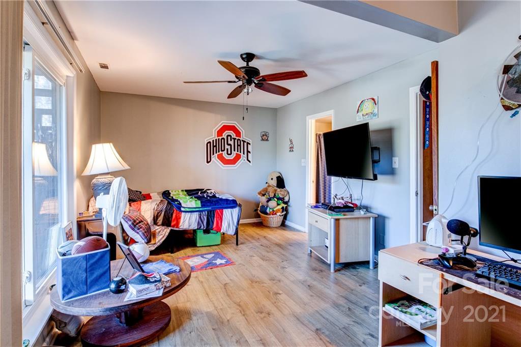 10043 Tepa Place Tega Cay, SC 29708 - Photo 17 of 32 a view of a livingroom with furniture a flat screen tv and a window