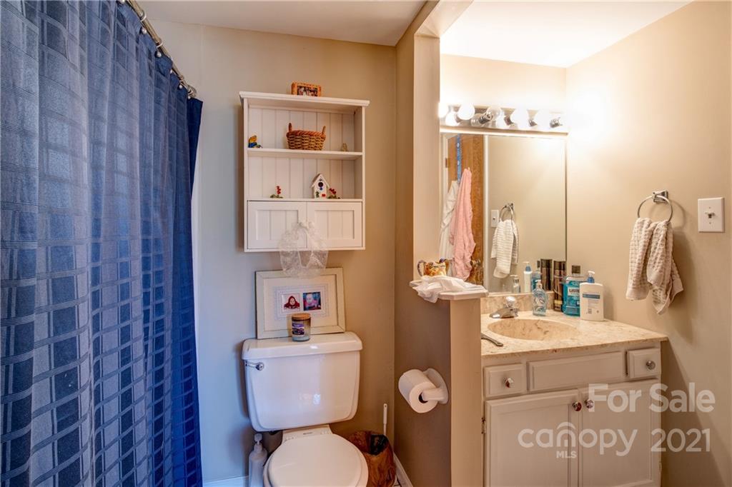 10043 Tepa Place Tega Cay, SC 29708 - Photo 18 of 32 a bathroom with a toilet sink and mirror