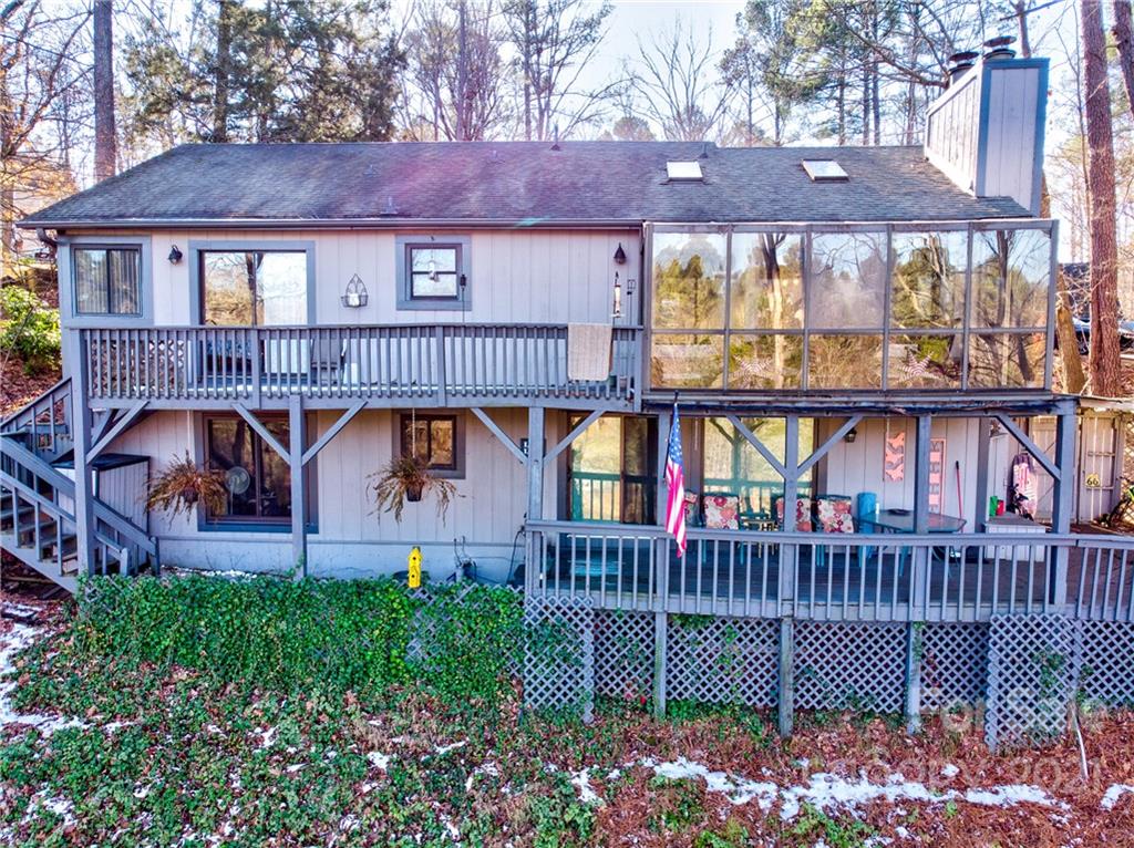 10043 Tepa Place Tega Cay, SC 29708 - Photo 22 of 32 a front view of a house with garden and deck