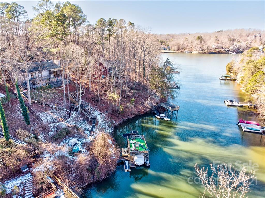 10043 Tepa Place Tega Cay, SC 29708 - Photo 27 of 32 a backyard of a house with lots of green space and lake view
