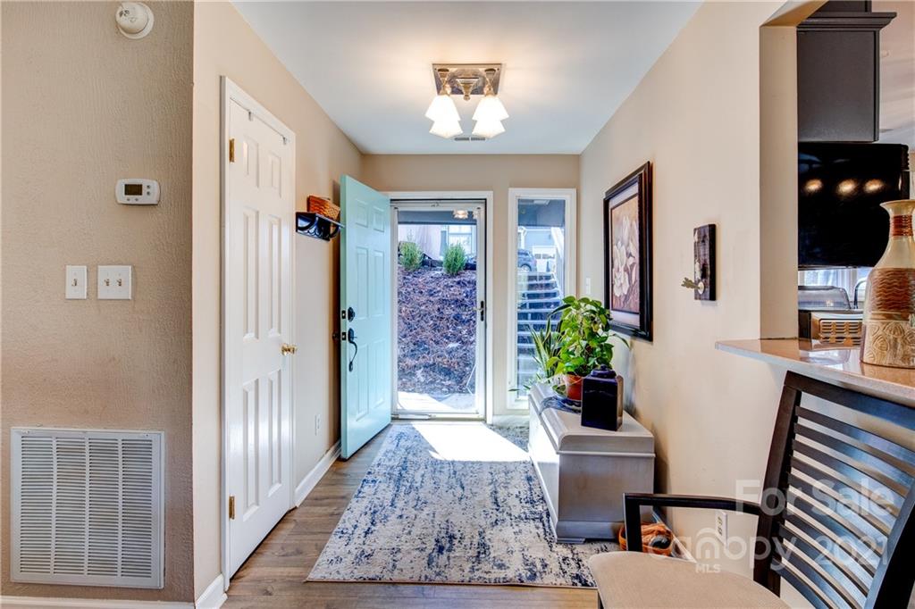 10043 Tepa Place Tega Cay, SC 29708 - Photo 3 of 32 a living room with furniture and a chandelier