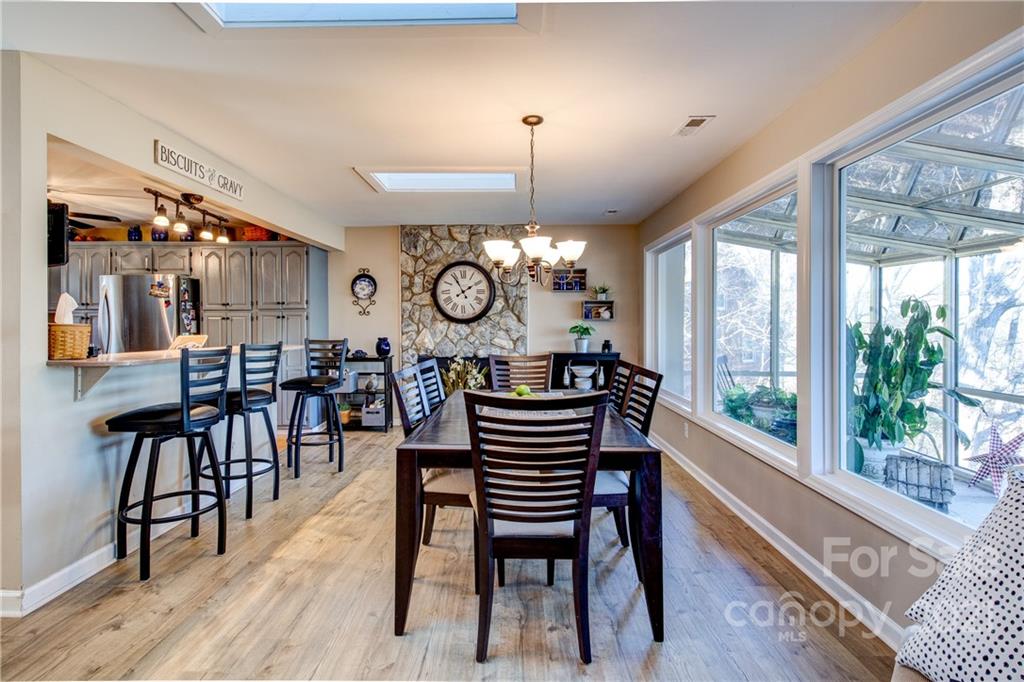 10043 Tepa Place Tega Cay, SC 29708 - Photo 5 of 32 a view of a dining room with furniture window and wooden floor