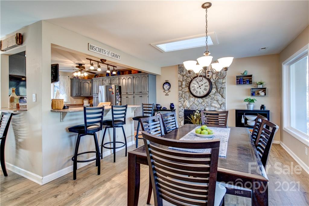 10043 Tepa Place Tega Cay, SC 29708 - Photo 6 of 32 a view of a dining room filled with furniture and chandelier