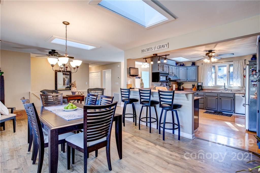 10043 Tepa Place Tega Cay, SC 29708 - Photo 7 of 32 a view of a dining room with furniture and wooden floor