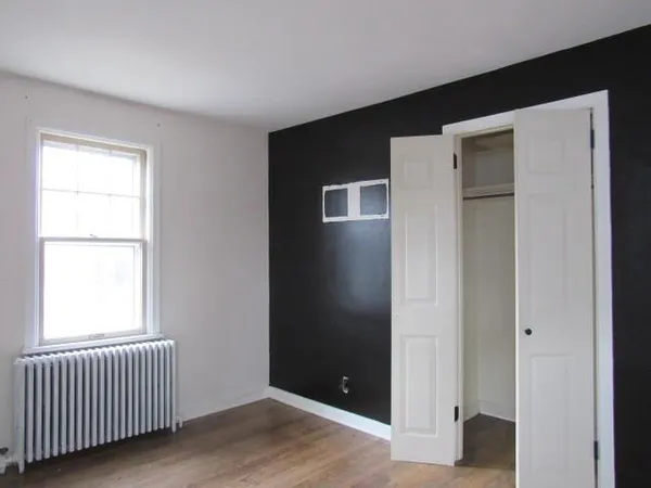 an empty room with wooden floor