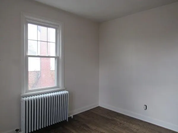 a view of a room with a furniture and a ceiling fan