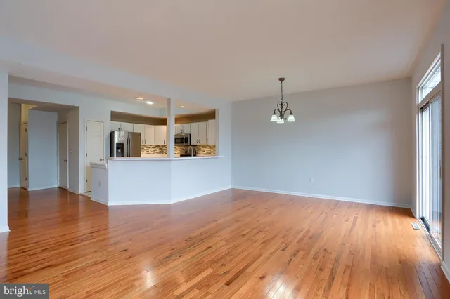 a view of a kitchen with wooden floor and a kitchen