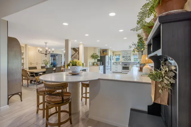 a spacious bedroom with a bed and a chandelier