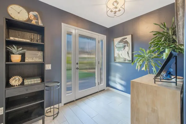 a living room with furniture and a chandelier