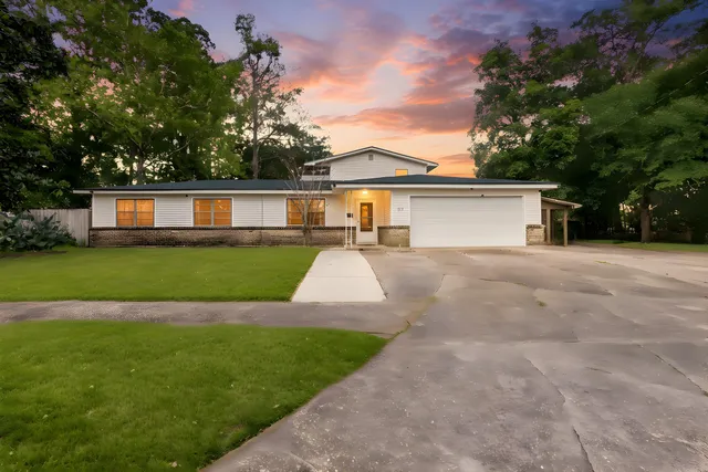 a view of a house with a yard and sitting area