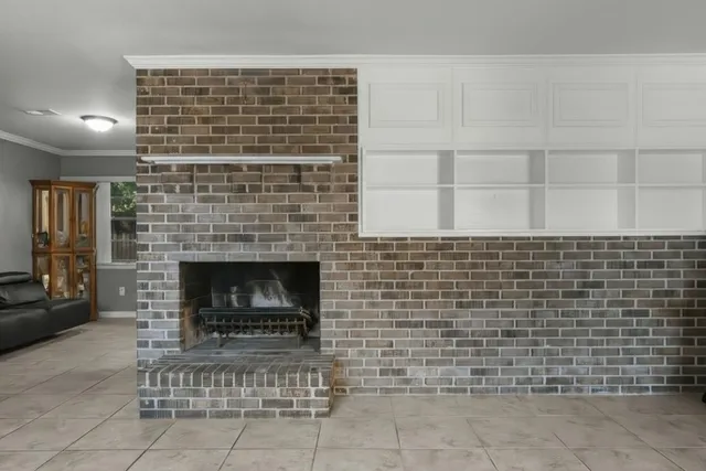 a large white kitchen with a sink and a refrigerator