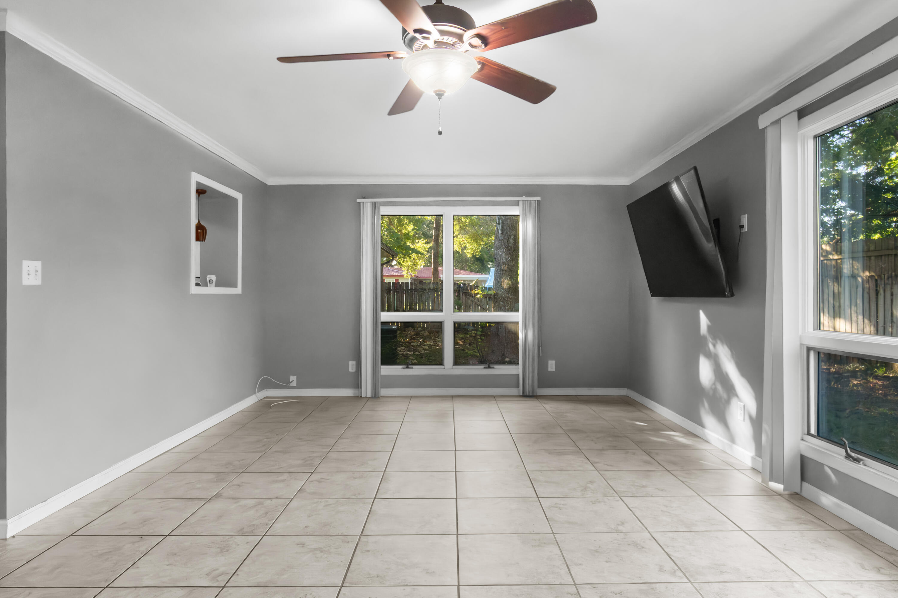 512 Lang Road Fort Walton Beach, FL 32547 - Photo 19 of 51 a view of an empty room with a window and a flat screen tv