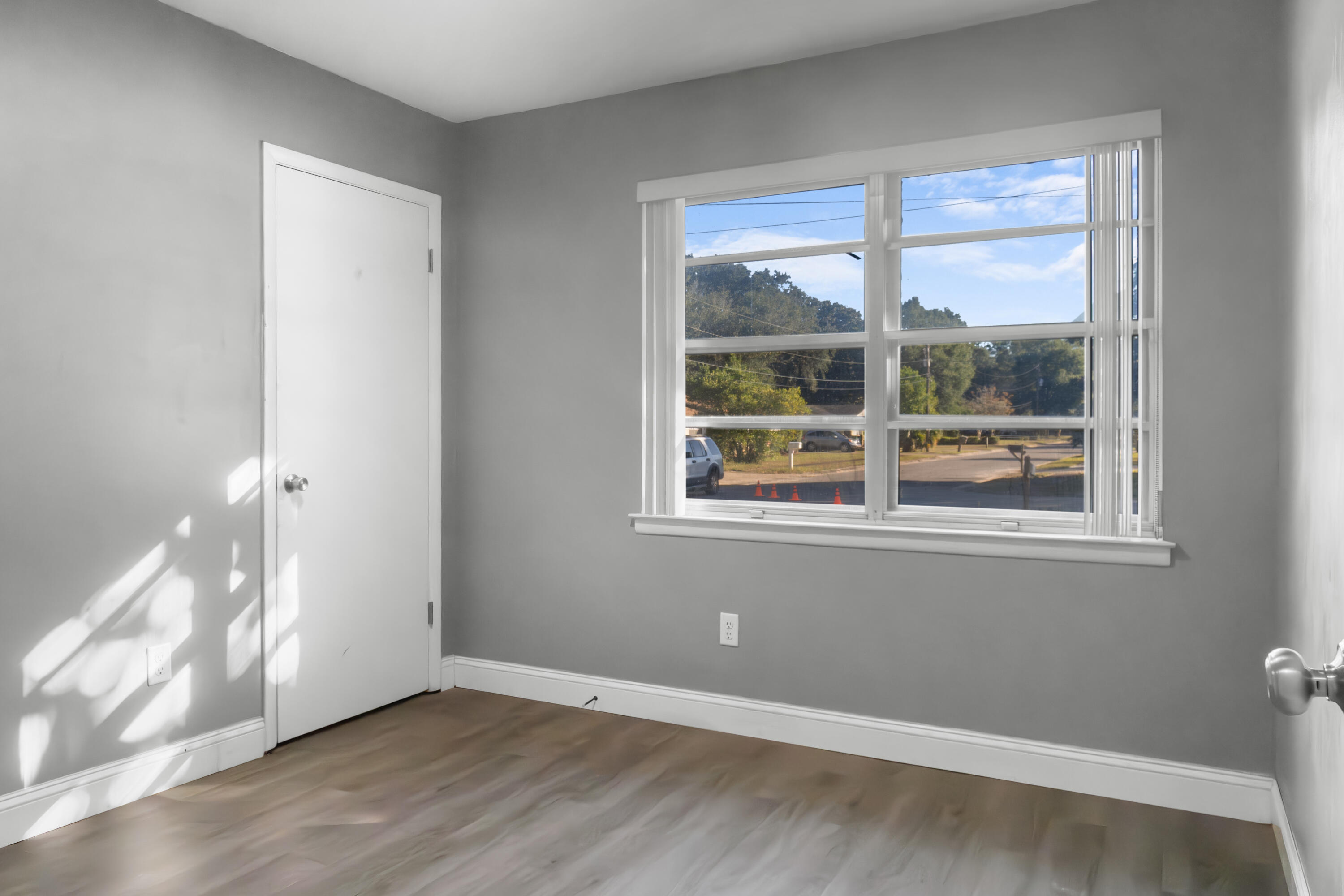 512 Lang Road Fort Walton Beach, FL 32547 - Photo 26 of 51 a view of an empty room with wooden floor and a window