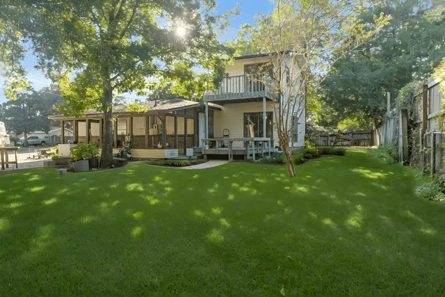 a view of a house with a yard and sitting area