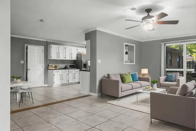 a living room with furniture and kitchen view