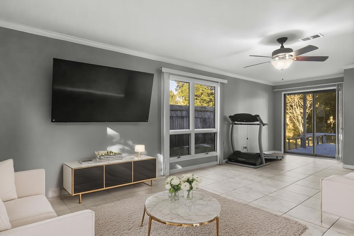 512 Lang Road Fort Walton Beach, FL 32547 - Photo 8 of 51 a living room with furniture a flat screen tv and a window