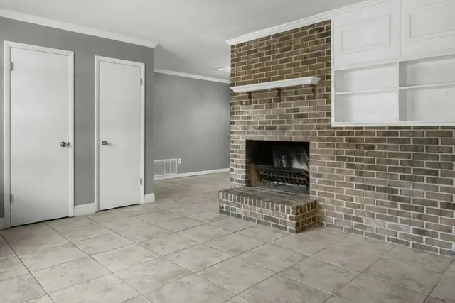 a view of empty room with fireplace