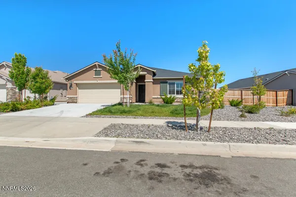 a front view of a house with a yard and a garage
