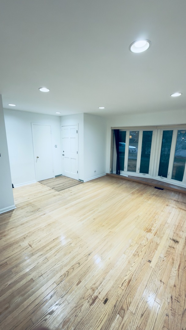 7 Wildwood Road Elk Grove Village, IL 60007 - Photo 2 of 7 a view of an empty room with wooden floor