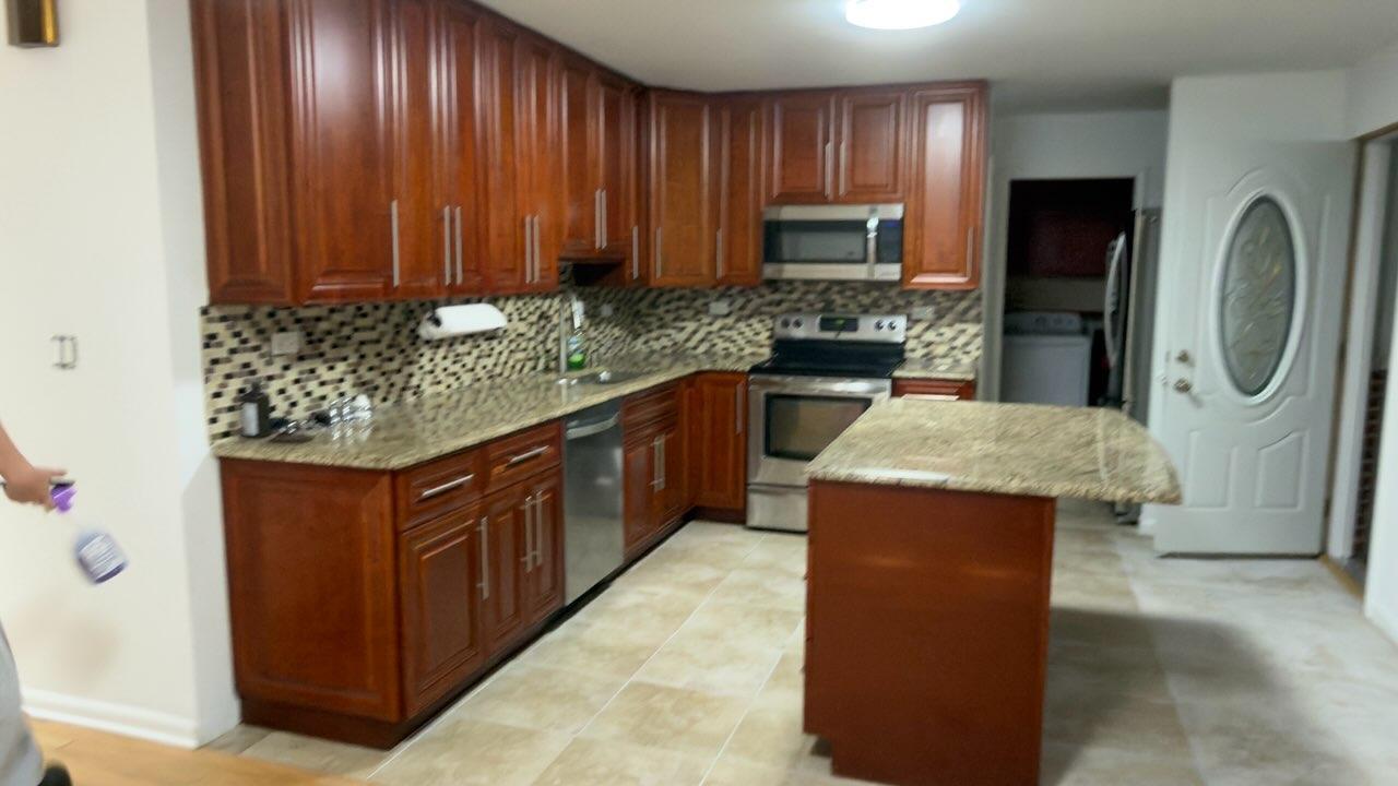 7 Wildwood Road Elk Grove Village, IL 60007 - Photo 3 of 7 a kitchen with stainless steel appliances granite countertop wooden cabinets a refrigerator and a sink