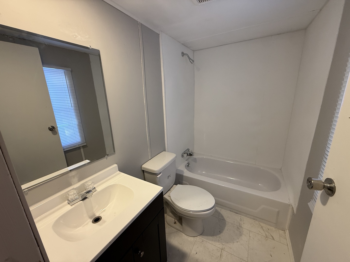 1712 South Dixie Highway, Unit 19 Crete, IL 60417 - Photo 6 of 12 a bathroom with a sink a toilet and shower