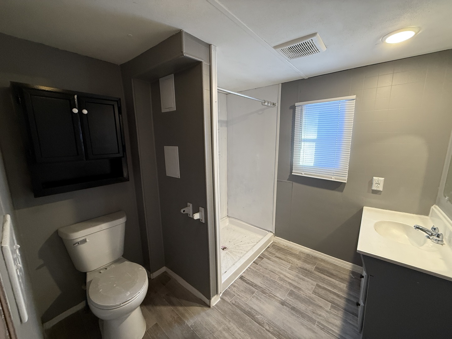 1712 South Dixie Highway, Unit 19 Crete, IL 60417 - Photo 9 of 11 a bathroom with a toilet sink and mirror
