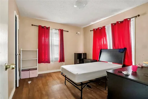 a living room with a bed and large window