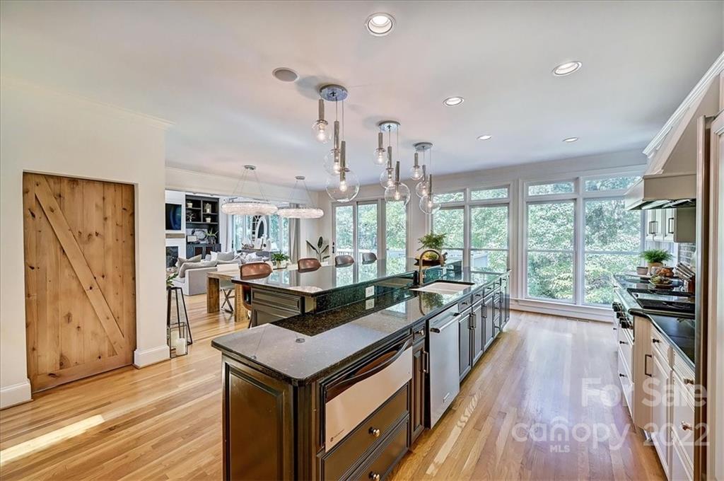 18600 Hammock Lane Davidson, NC 28036 - Photo 15 of 48 a kitchen with stainless steel appliances granite countertop a stove and a wooden floors