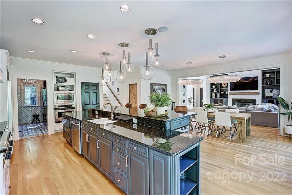 18600 Hammock Lane Davidson, NC 28036 - Photo 17 of 48 a kitchen with stainless steel appliances granite countertop a stove and a wooden floors
