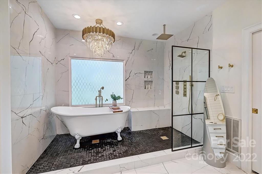 18600 Hammock Lane Davidson, NC 28036 - Photo 23 of 48 a spacious bathroom with a sink a mirror and a shower